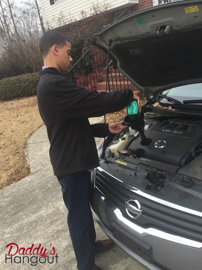 My Son adding oil to help take care of your car #WalmartAuto