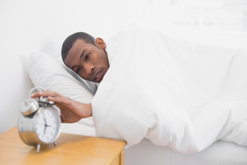 Man Hitting the Snooze Button