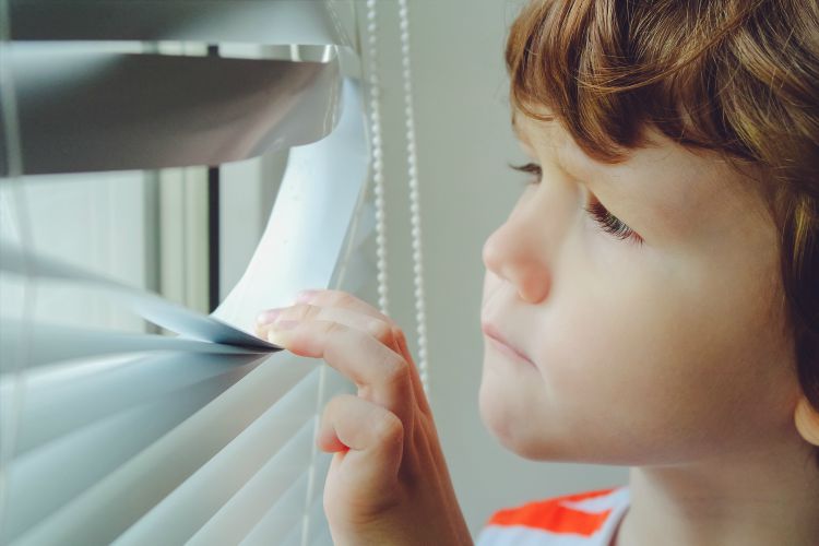Child Looking Through Blinds